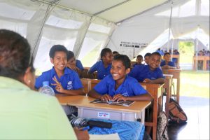 Fijian school children in tent classroom. Photo DFAT Public Affairs Suva